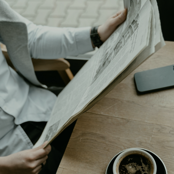 Someone at a coffee shop reading a paper